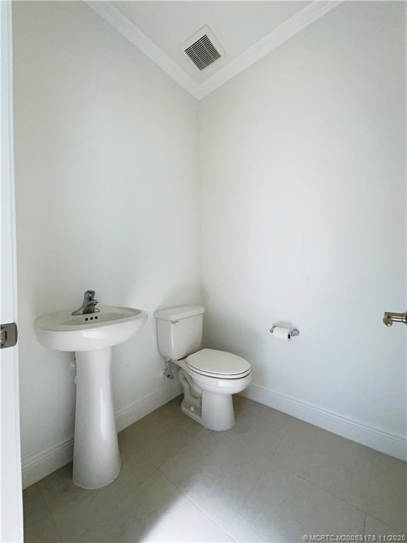 860 Southwest Bushel Trail Palm City, FL 34990 - Photo 24 of 25 a white toilet sitting next to a white sink