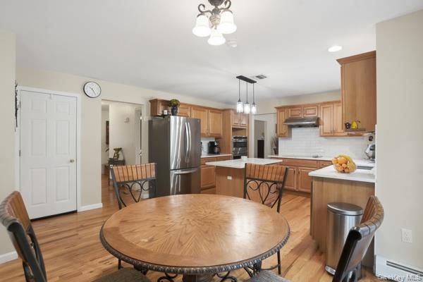 29 Hickory Hill Road Newburgh, NY 12550 - Photo 23 of 47 a kitchen with stainless steel appliances a dining table chairs and wooden floor
