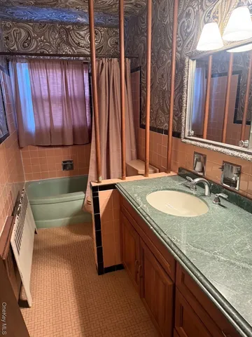 a bathroom with a sink and a mirror