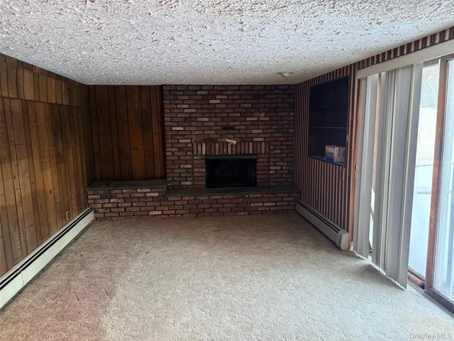 an empty room with a fireplace and window
