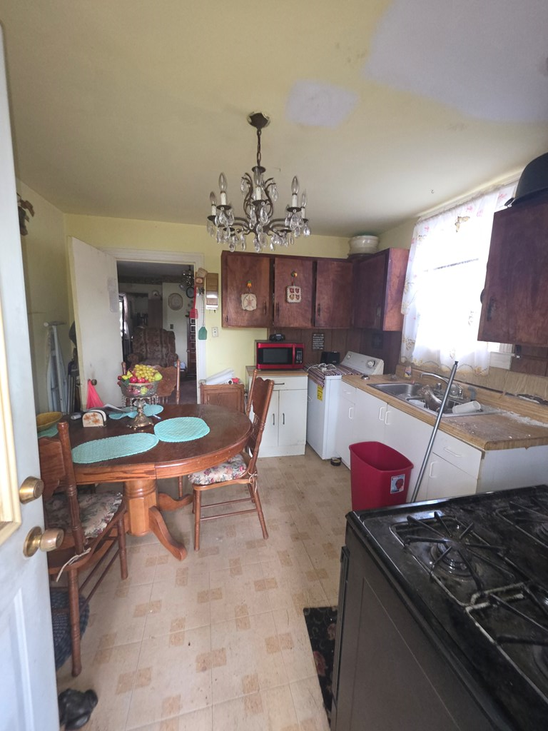 1352 24th Street Columbus, GA 31901 - Photo 12 of 18 a kitchen with stainless steel appliances granite countertop a stove and a dining table view