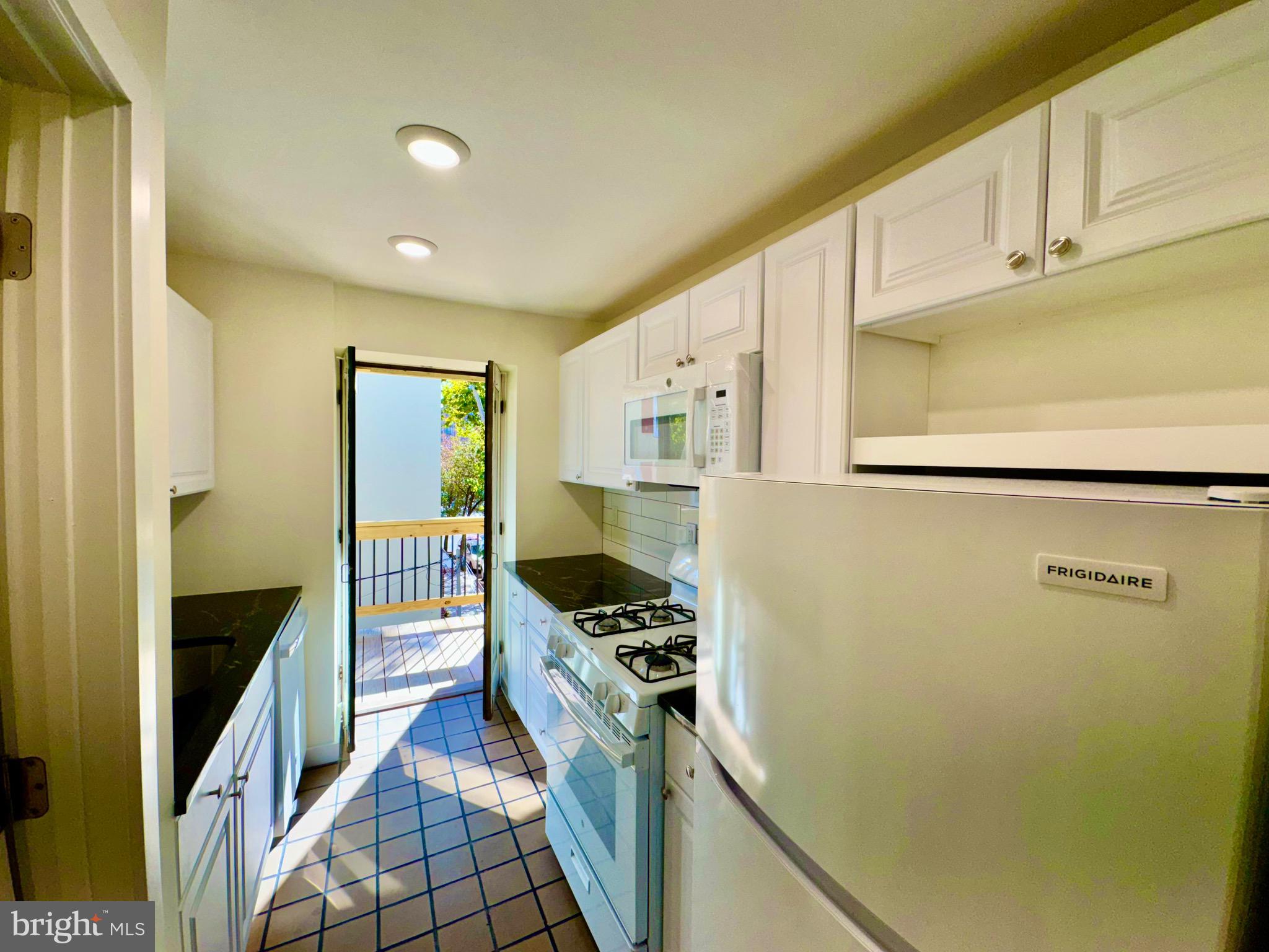 2148 Green Street, Unit 2 Philadelphia, PA 19130 - Photo 19 of 27 a kitchen with stainless steel appliances a refrigerator and a stove