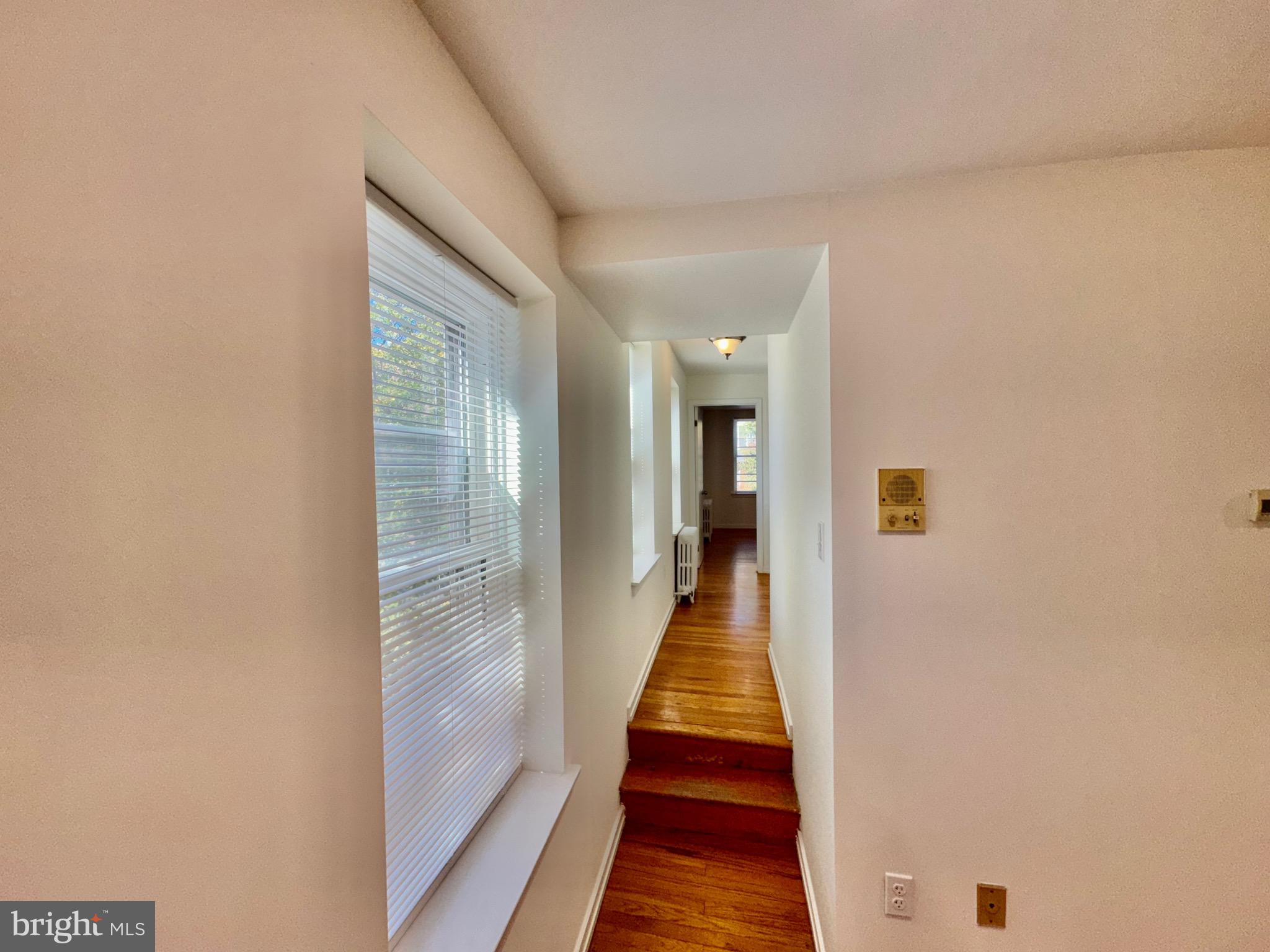 2148 Green Street, Unit 2 Philadelphia, PA 19130 - Photo 20 of 27 a hallway with wooden floor and a bathroom