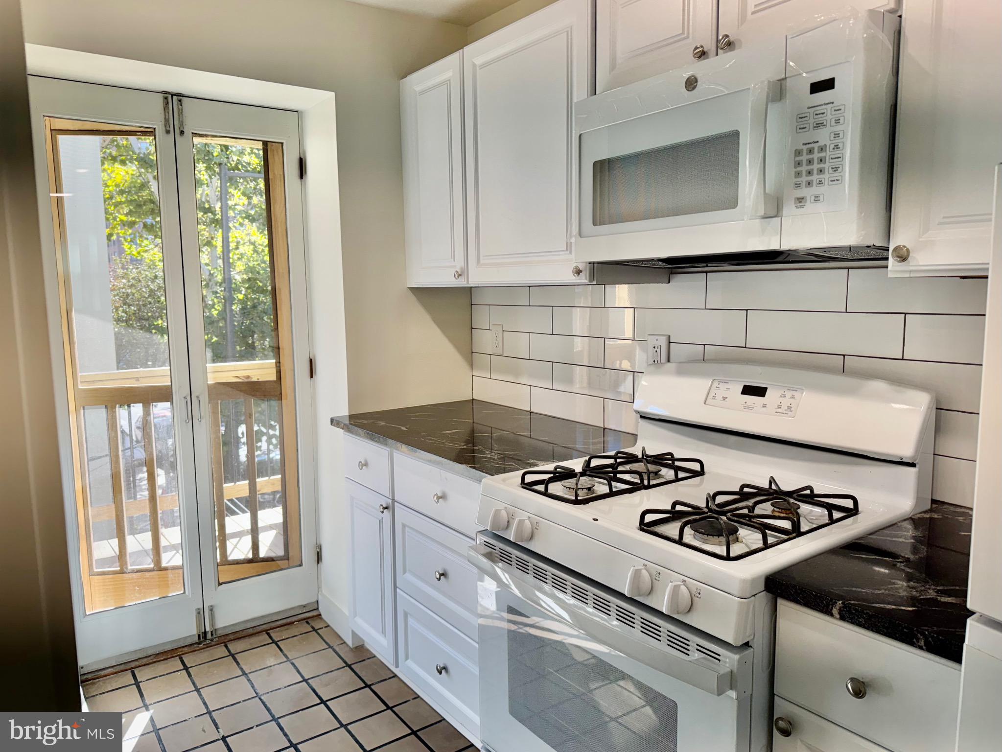 2148 Green Street, Unit 2 Philadelphia, PA 19130 - Photo 2 of 27 a white stove top oven sitting inside of a kitchen