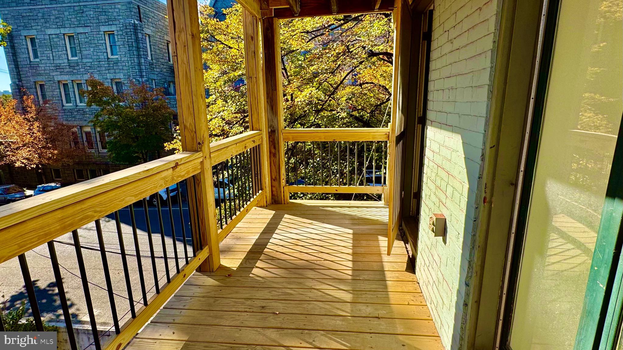2148 Green Street, Unit 2 Philadelphia, PA 19130 - Photo 22 of 27 a view of a balcony with wooden floor and stairs