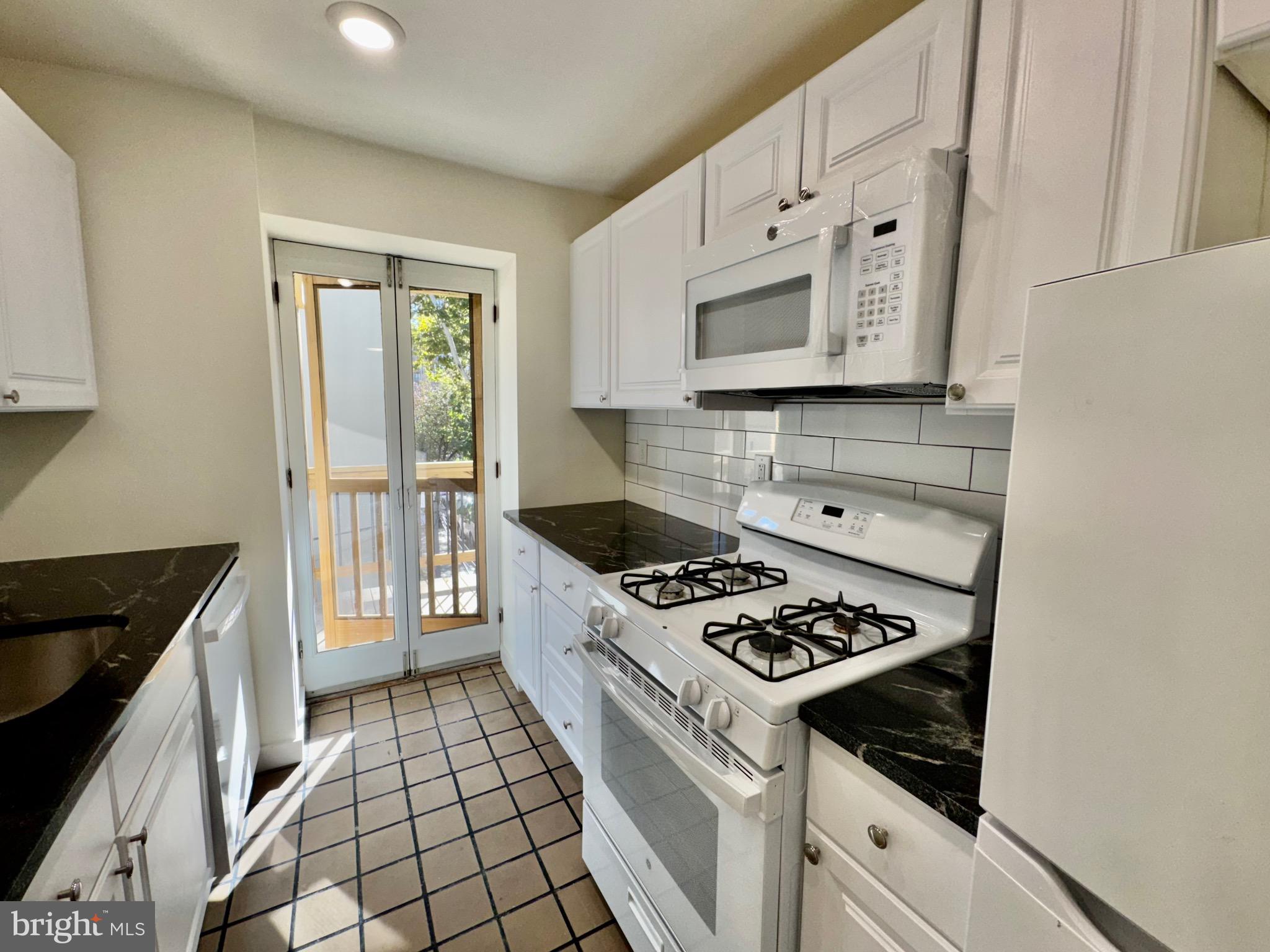 2148 Green Street, Unit 2 Philadelphia, PA 19130 - Photo 4 of 27 a kitchen with cabinets and appliances