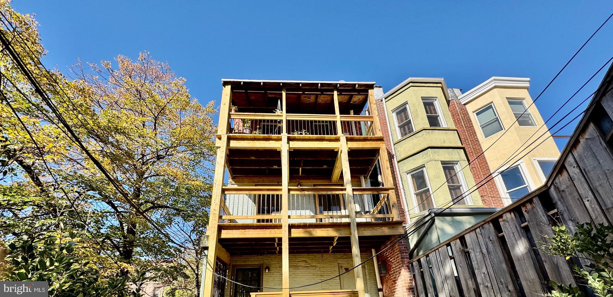 2148 Green Street, Unit 2 Philadelphia, PA 19130 - Photo 5 of 27 a view of a blue house with a large window and flower plants