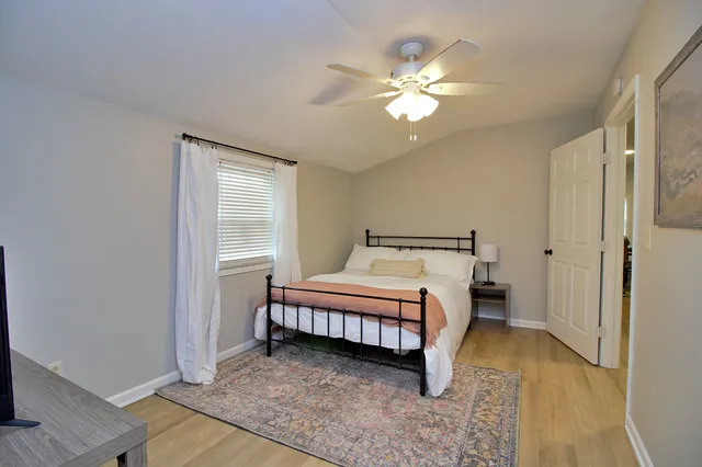 a bedroom with a bed and a chandelier