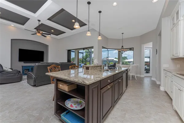 a living room with furniture kitchen and a chandelier