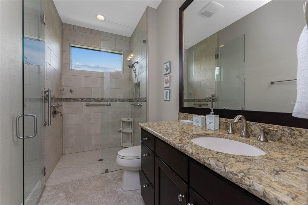 2730 Rio Court Punta Gorda, FL 33950 - Photo 23 of 71 a bathroom with a granite countertop sink a toilet and shower