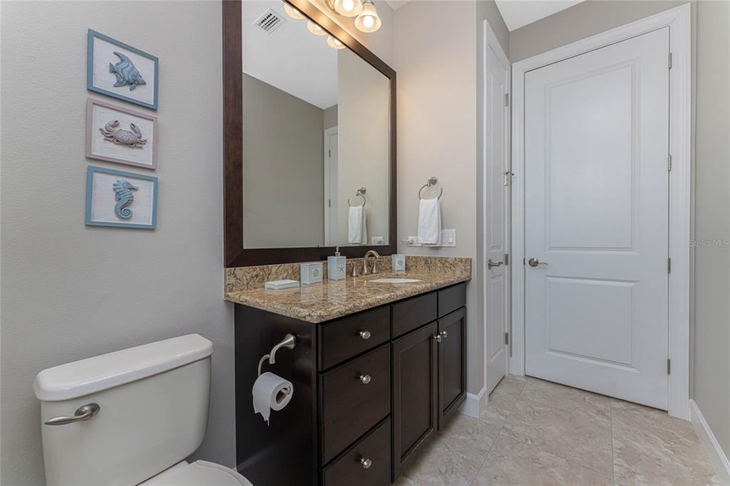 2730 Rio Court Punta Gorda, FL 33950 - Photo 25 of 71 a bathroom with a granite countertop toilet a sink and a mirror