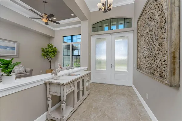 a dining room with furniture a chandelier and window