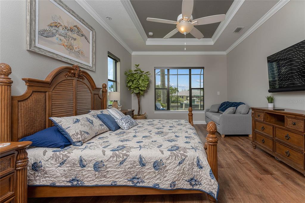 2730 Rio Court Punta Gorda, FL 33950 - Photo 33 of 71 a bedroom with a large bed and a chandelier