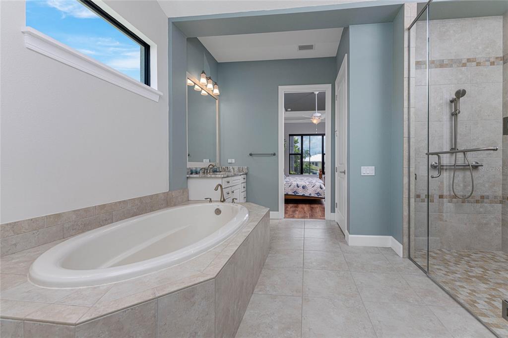 2730 Rio Court Punta Gorda, FL 33950 - Photo 39 of 71 a spacious bathroom with a tub shower and mirror
