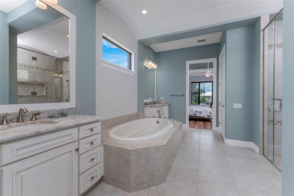 2730 Rio Court Punta Gorda, FL 33950 - Photo 40 of 71 a spacious bathroom with a double vanity sink a mirror and a bathtub