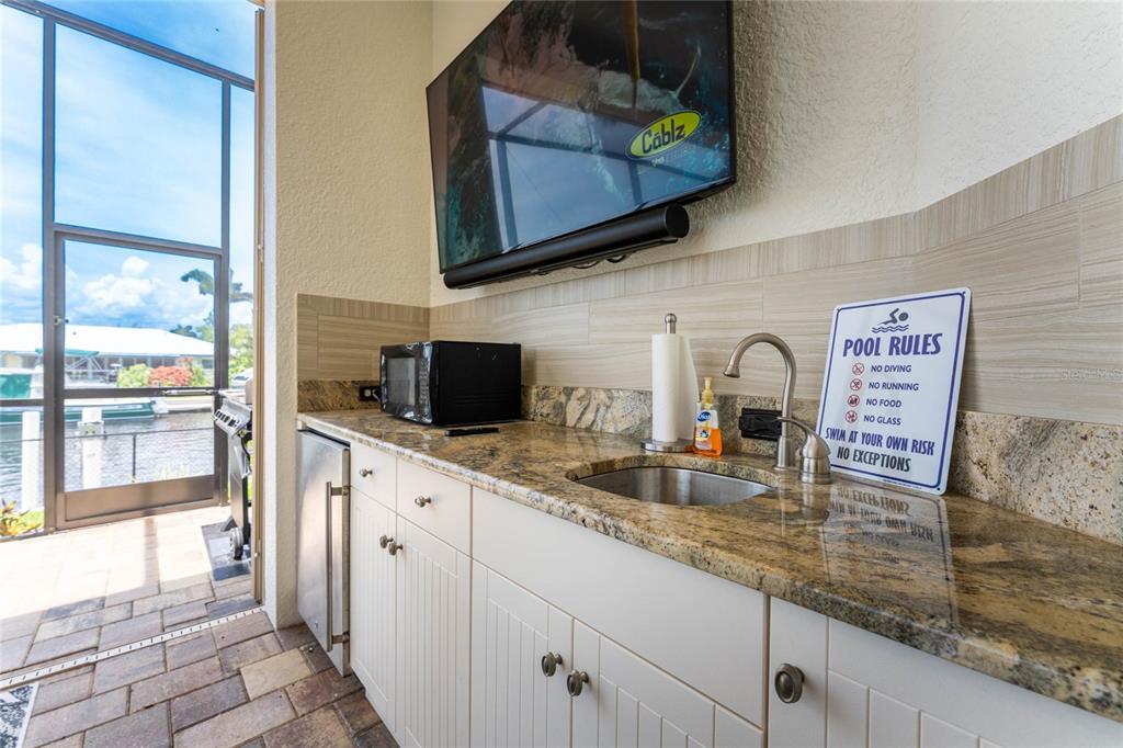 2730 Rio Court Punta Gorda, FL 33950 - Photo 45 of 71 a kitchen with stainless steel appliances granite countertop a sink and a microwave