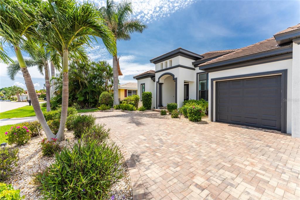 2730 Rio Court Punta Gorda, FL 33950 - Photo 60 of 71 a front view of a house with a yard and garage