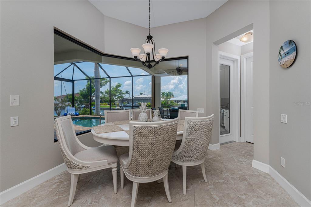 2730 Rio Court Punta Gorda, FL 33950 - Photo 6 of 71 a dining room with furniture a chandelier and window