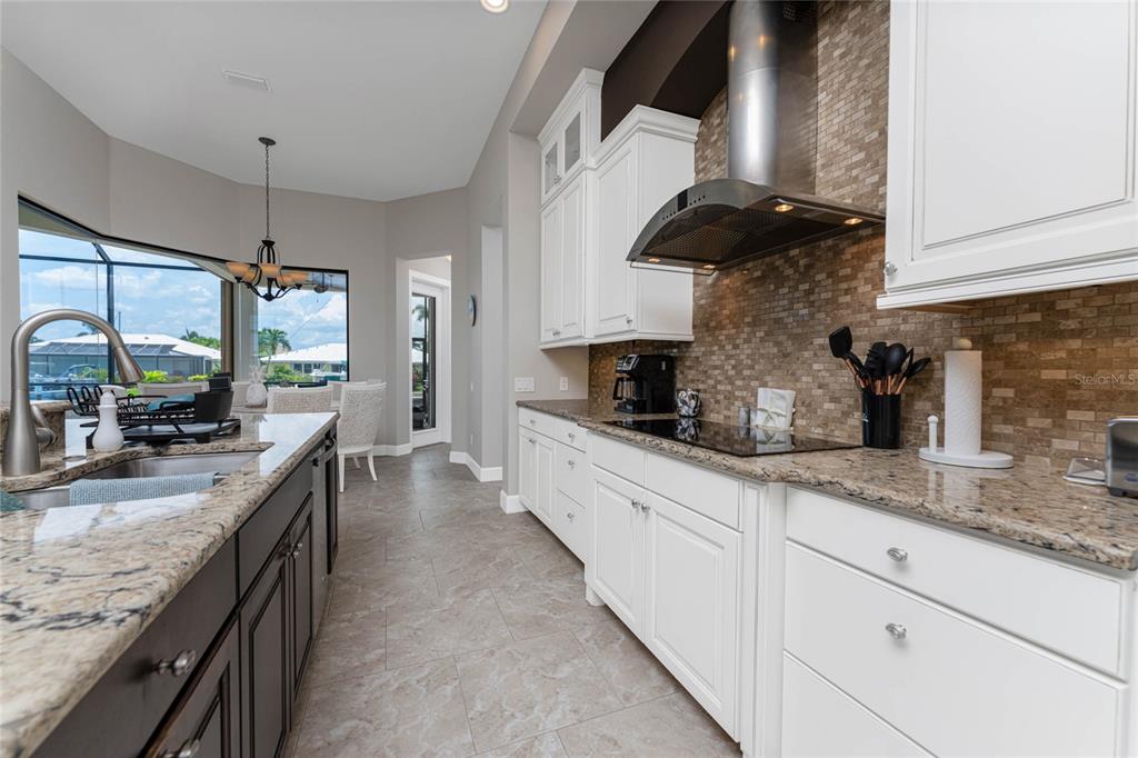 2730 Rio Court Punta Gorda, FL 33950 - Photo 10 of 71 a kitchen with stainless steel appliances granite countertop a sink a stove and a wooden cabinets
