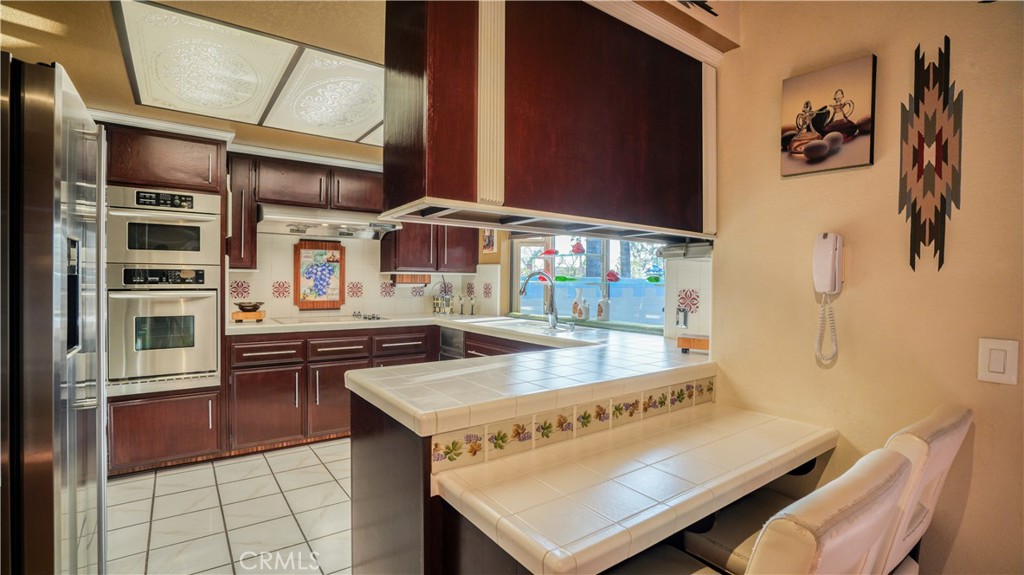 2117 Capuchin Way Claremont, CA 91711 - Photo 12 of 36 a kitchen with stainless steel appliances granite countertop a stove and a refrigerator