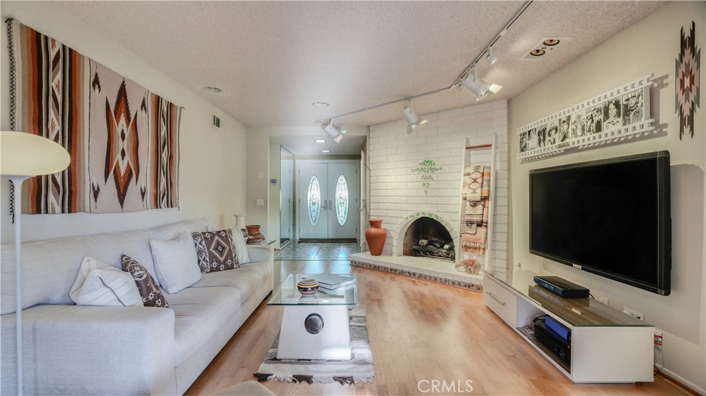 2117 Capuchin Way Claremont, CA 91711 - Photo 16 of 36 a living room with furniture and a flat screen tv