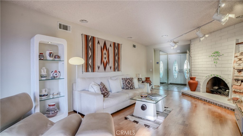 2117 Capuchin Way Claremont, CA 91711 - Photo 17 of 36 a living room with furniture and a fireplace