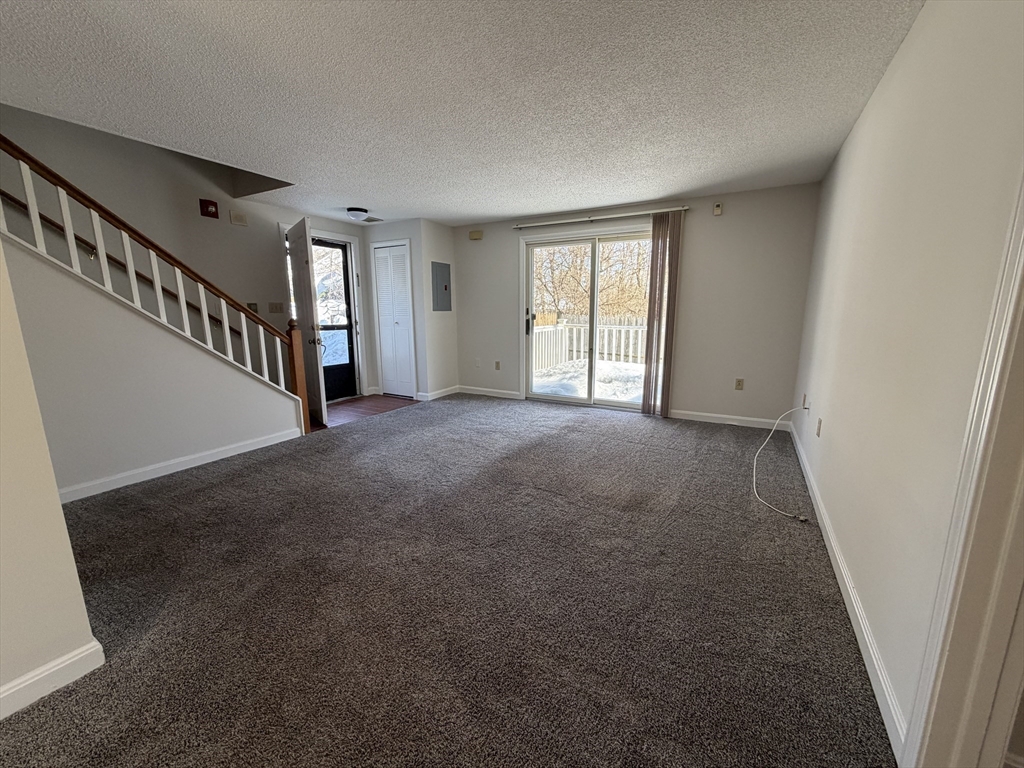 213 Victoria Heights Road, Unit 213 Boston, MA 02136 - Photo 1 of 18 a view of an empty room with a window