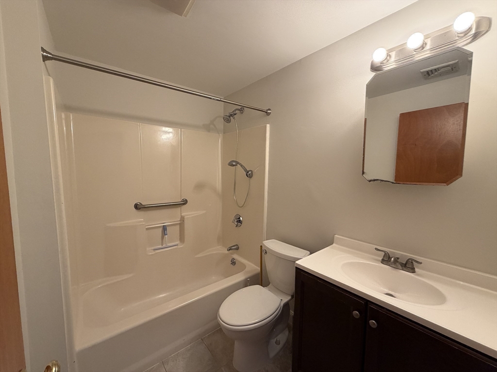 213 Victoria Heights Road, Unit 213 Boston, MA 02136 - Photo 14 of 18 a bathroom with a granite countertop sink toilet and shower