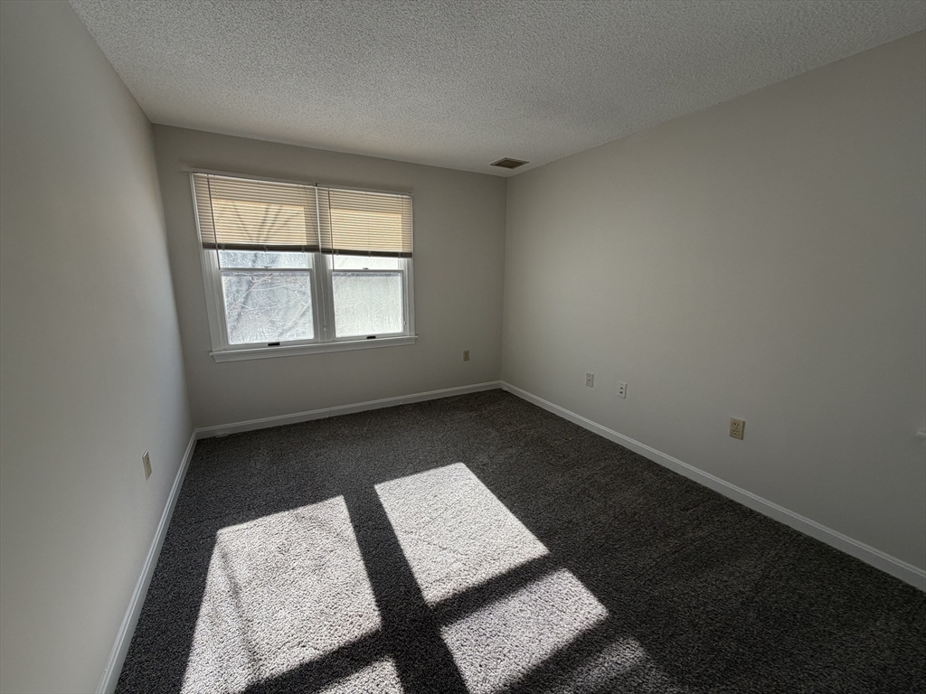 213 Victoria Heights Road, Unit 213 Boston, MA 02136 - Photo 16 of 18 an empty room with a chair
