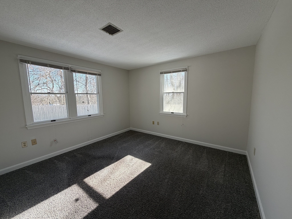 213 Victoria Heights Road, Unit 213 Boston, MA 02136 - Photo 8 of 18 a view of an empty room with a window
