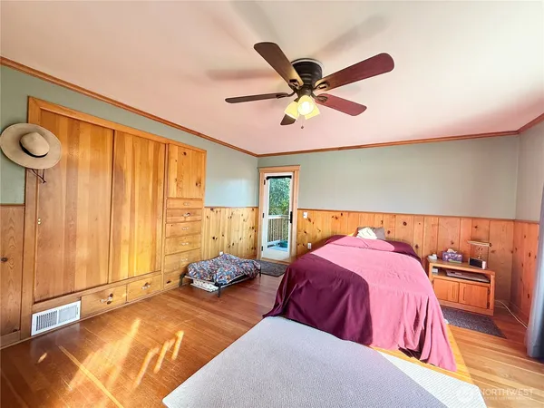 a bedroom with two beds and a large window