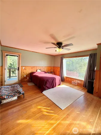 a large bedroom with a large bed and a large window
