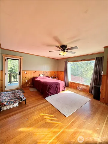 a large bedroom with a large bed and a large window