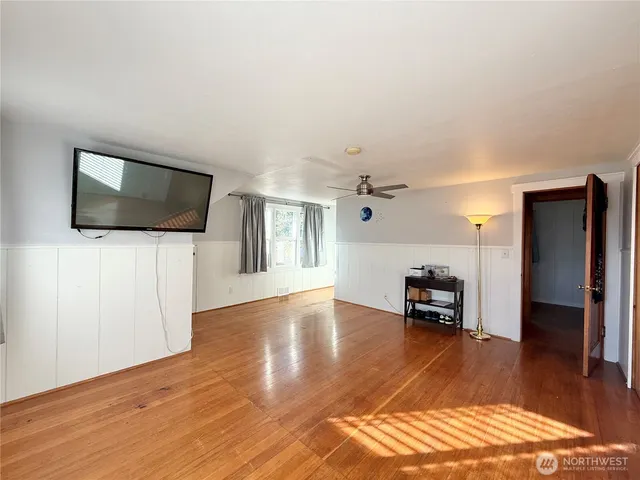 wooden floor in an empty room with a window
