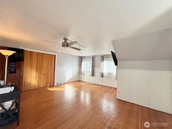 a view of empty room with wooden floor