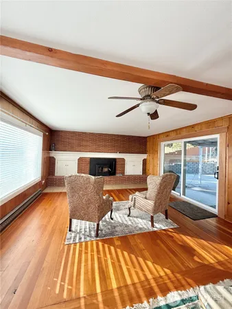 a living room with furniture rug and wooden floor