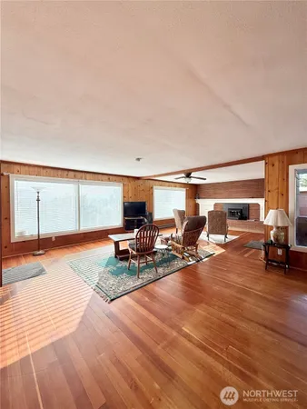 a dining room with furniture and wooden floor