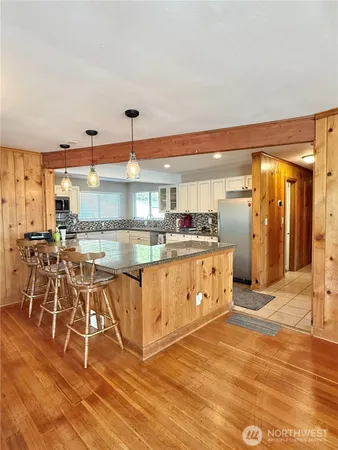 a large white kitchen with a large window