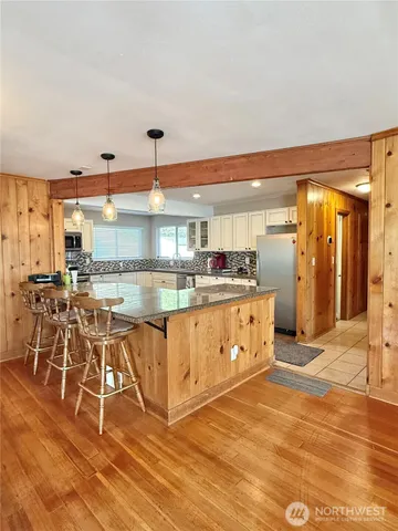 a large white kitchen with a large window