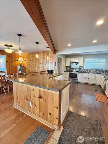 a kitchen with stainless steel appliances granite countertop a sink and cabinets