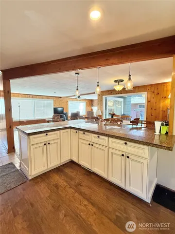 a large kitchen with cabinets and wooden floor