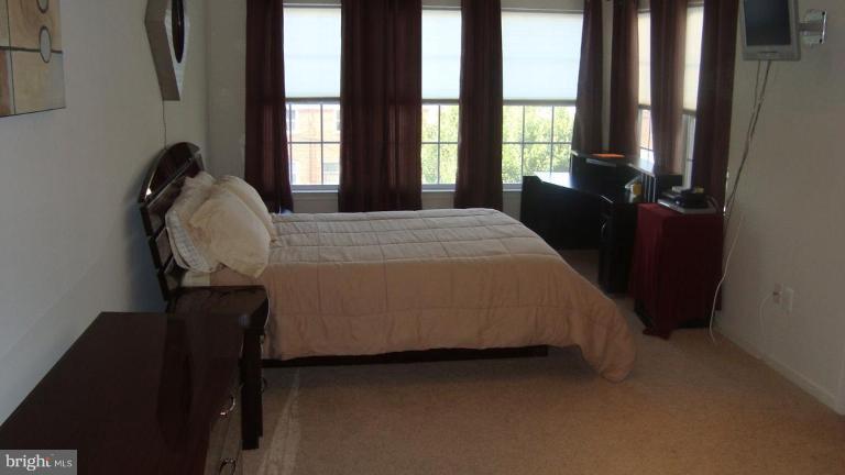 9860 Decatur Road Middle River, MD 21220 - Photo 5 of 7 a bed sitting in a bedroom next to a window