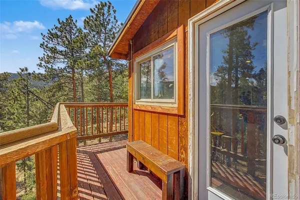 a view of a balcony with wooden floor and fence