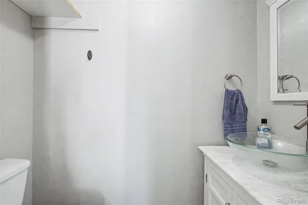 a bathroom with a sink vanity and toilet