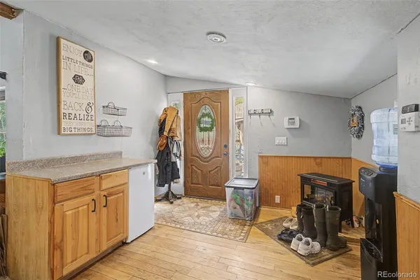 a view of a livingroom with wooden floor and furniture