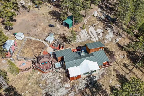 an aerial view of a house with garden space and street view
