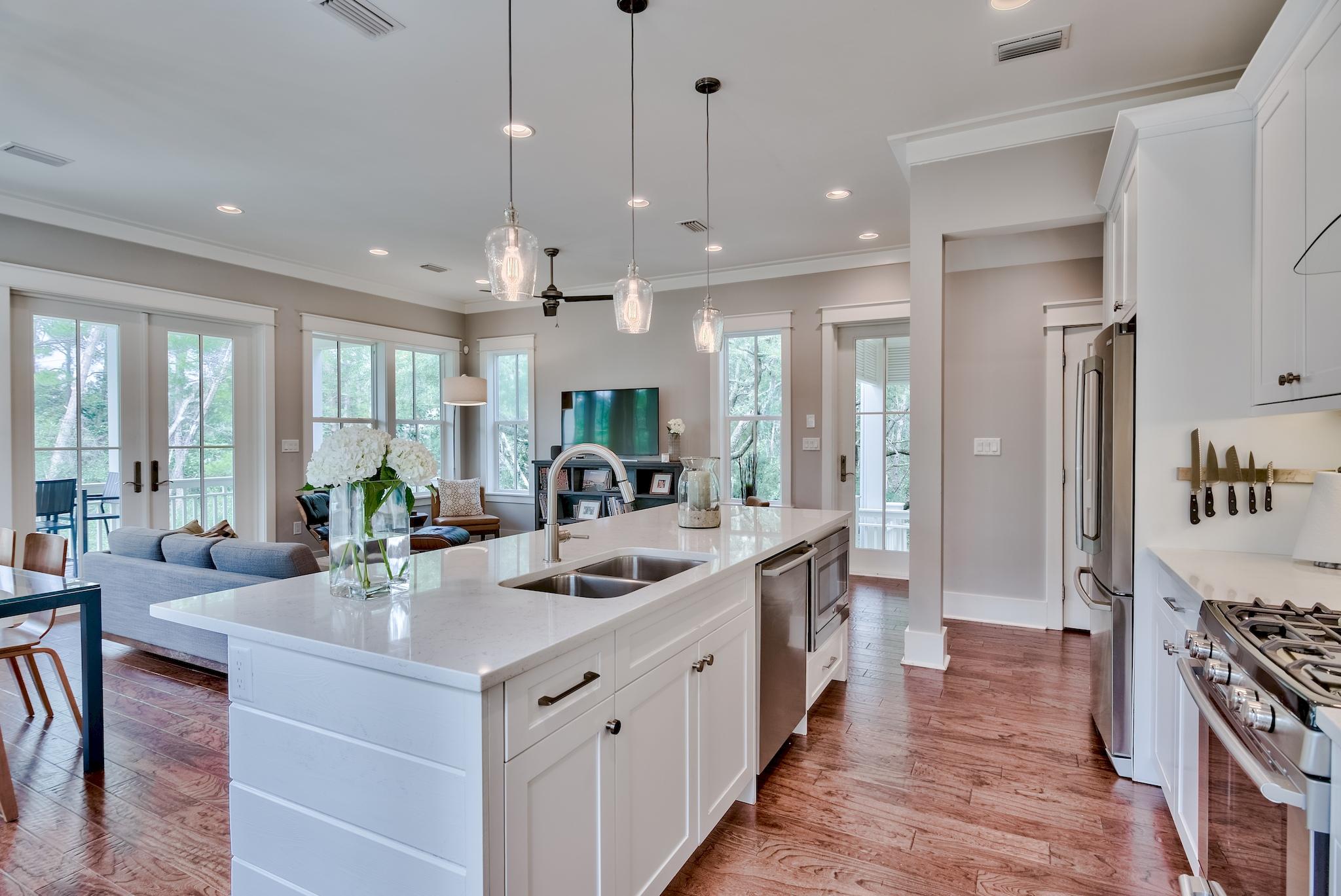 97 Okeechobee West Santa Rosa Beach, FL 32459 - Photo 11 of 46 a large white kitchen with a large island oven a stove a sink and a refrigerator