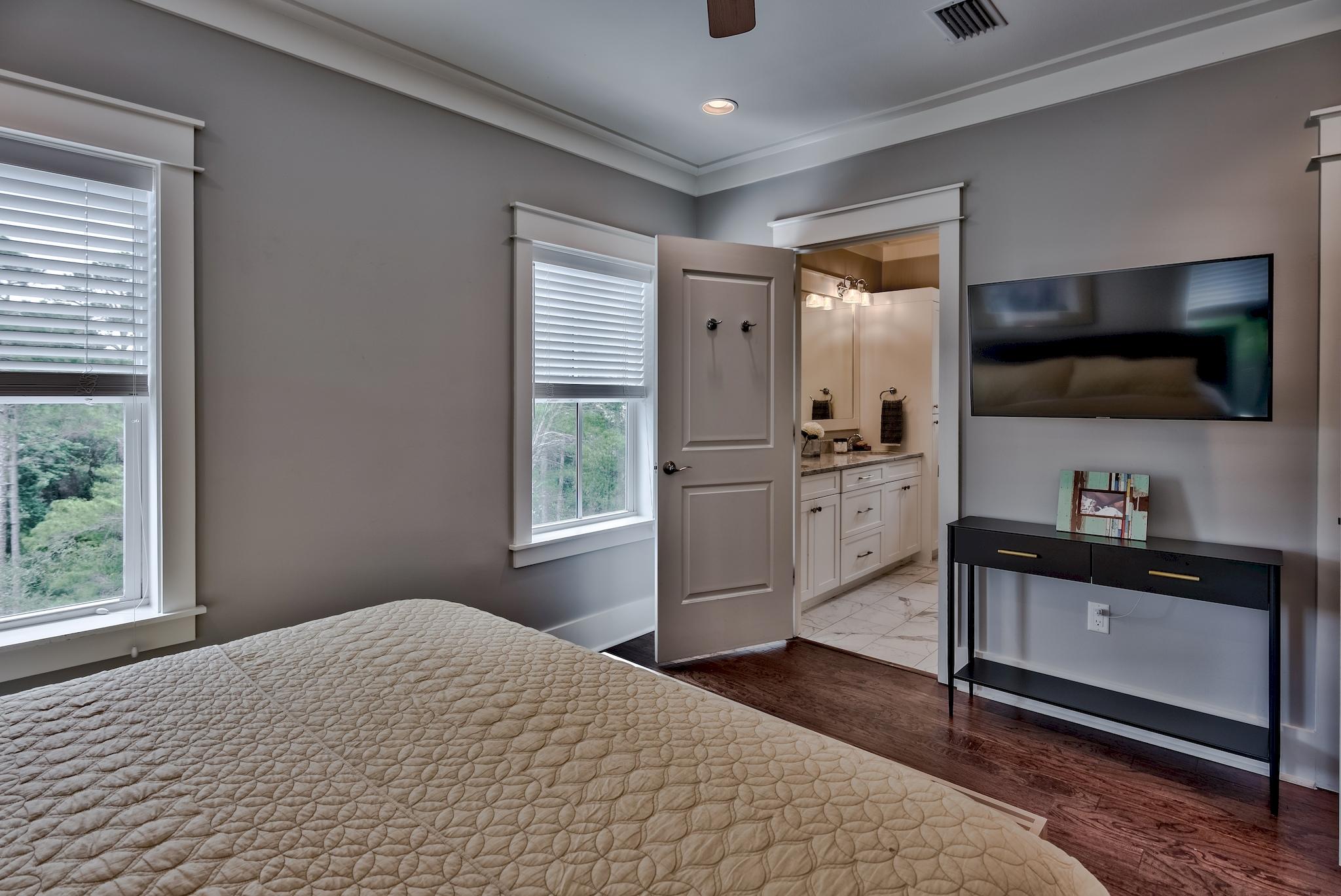 97 Okeechobee West Santa Rosa Beach, FL 32459 - Photo 22 of 46 a bedroom with a bed and a flat screen tv