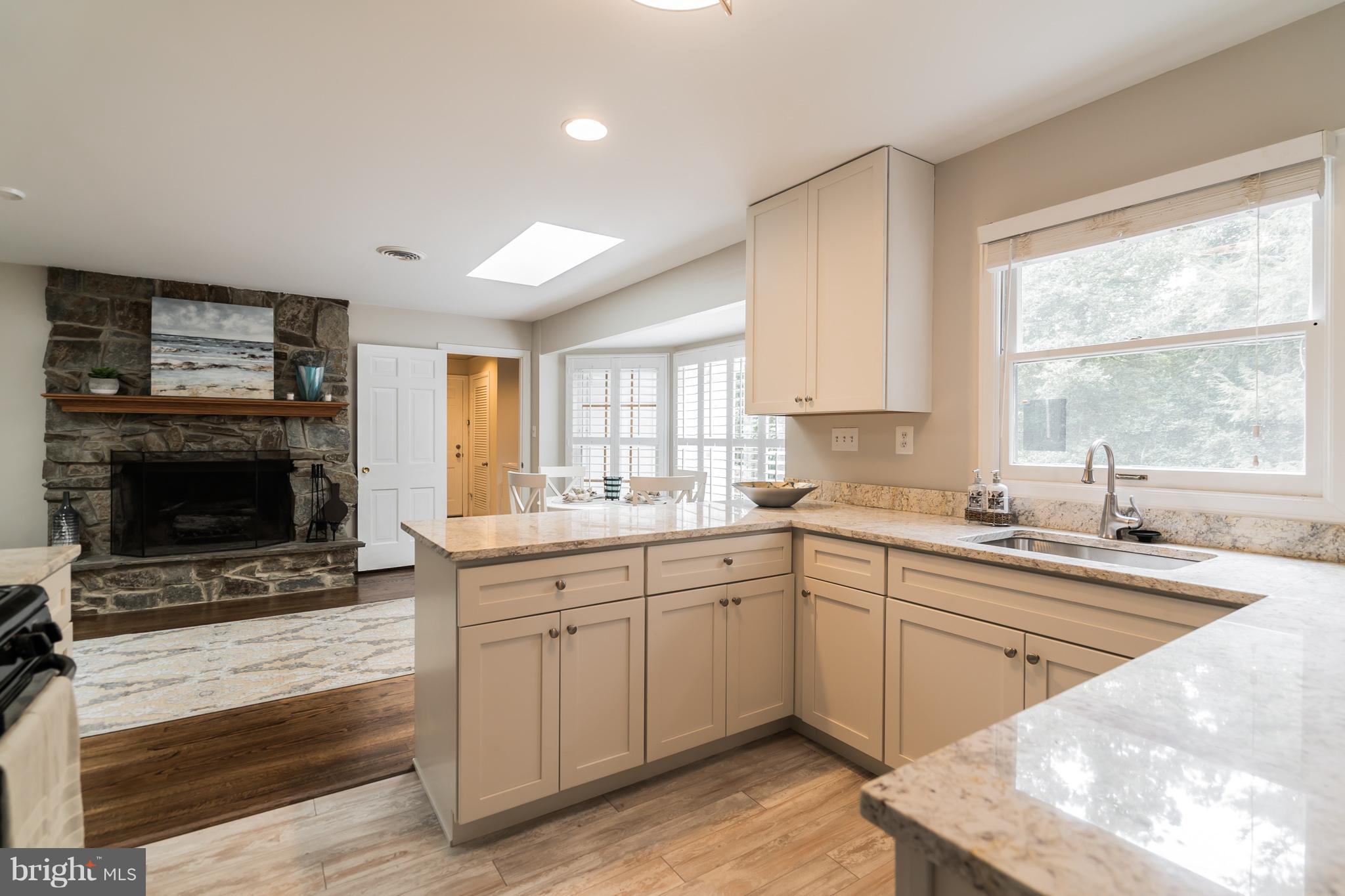 9541 Warfield Road Gaithersburg, MD 20882 - Photo 8 of 29 Kitchen great room has a cozy stone fireplace.
