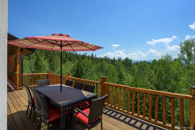 a view of a dining room with furniture and a chandelier